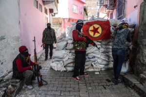 A flag of Kurdish workers Party (PKK) hangs on a barricade as armed kurdish militants man a barricade, on November 18, 2015 in the Sur district of Diyarbakir. Tensions rose when pro-Kurdish MP Leyla Zana began her oath with "Biji Asiti", or "Long live peace" in Kurdish. The phrase triggered a storm that recalled her memorable swearing-in 24 years ago when she also spoke the language that was then still taboo in public. AFP PHOTO/ILYAS AKENGIN        (Photo credit should read ILYAS AKENGIN/AFP/Getty Images)